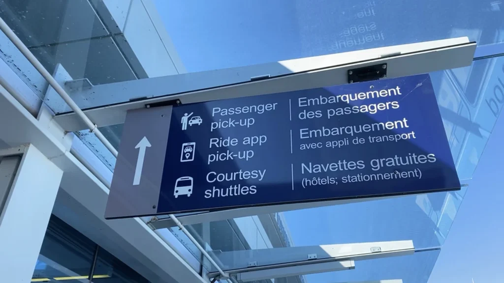 Luxury sedan pulling up to Billy Bishop Airport terminal entrance